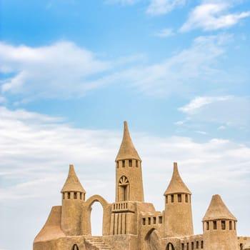 Sandcastle during a sunny day with blue sky background. Concept for summer, vacation, relax and fun.