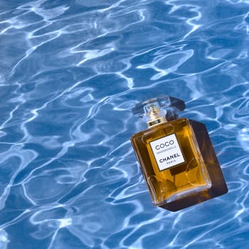 A bottle of Chanel perfume on the texture of the water background, with a beautiful shadow with highlights. Coco Chanel women's perfume series. Layout, layout, advertising, layout. 2020-07-05 Samara.