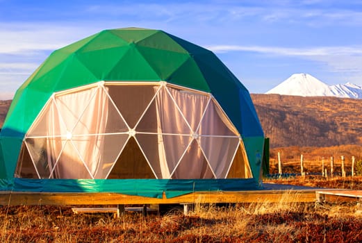 The Green geo-dome tent on Kamchatka peninsula. Cozy, camping, glamping, holiday, vacation lifestyle concept. Outdoors cabin, scenic background