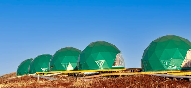 The Green geo-dome tent on Kamchatka peninsula. Cozy, camping, glamping, holiday, vacation lifestyle concept. Outdoors cabin, scenic background