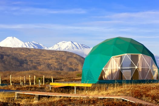 The Green geo-dome tent on Kamchatka peninsula. Cozy, camping, glamping, holiday, vacation lifestyle concept. Outdoors cabin, scenic background