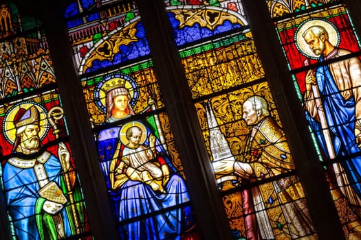 Quimper, Brittany, France - August 11 2017 : Stained glass in the Cathedral of Saint Corentin. Bishop his grace Graveran offering cathedral to Our Lady and St Corentin.