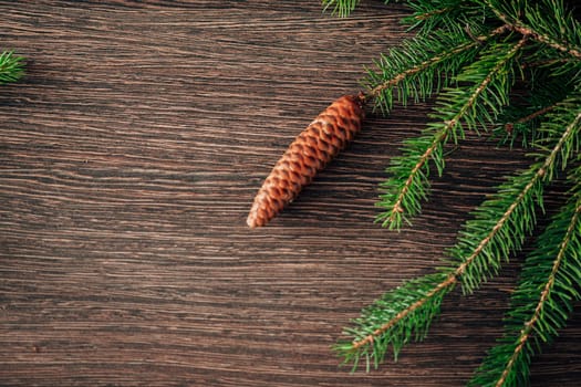 Decoration of Christmas Tree Green Branches on a Brown Background with CopySpace