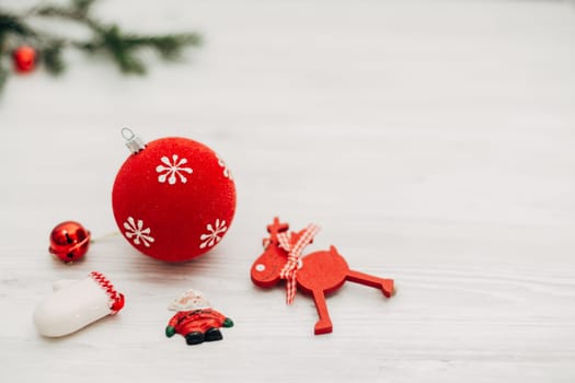 Christmas Red Decorations on a White Wooden Table with Copy Space Text