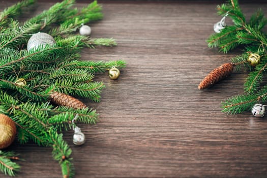 Decoration of Christmas Tree Green Branches on a Brown Background with CopySpace