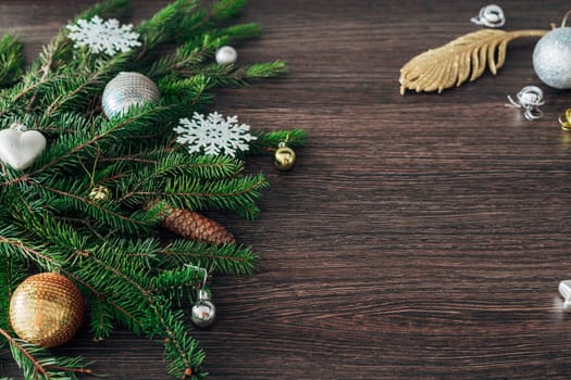 Decoration of Christmas Tree Green Branches on a Brown Background with Copy Space