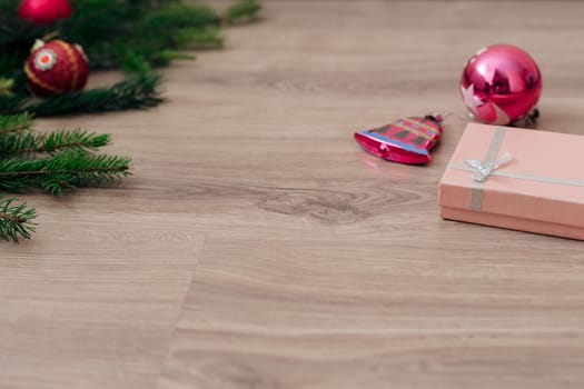 Decoration of Christmas Tree Green Branches on a Wooden Background with Copy Space