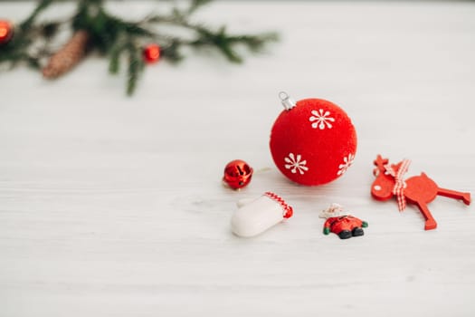 Christmas Red Decorations on a White Wooden Table with Copy Space Text