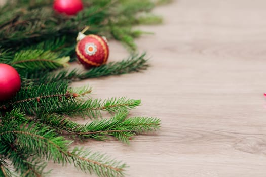 Decoration of Christmas Tree Green Branches on a Wooden Background with Copy Space