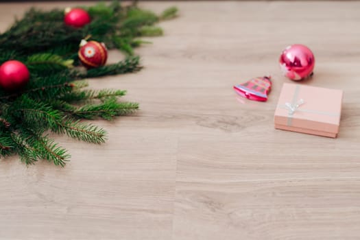 Decoration of Christmas Tree Green Branches on a Wooden Background with Copy Space