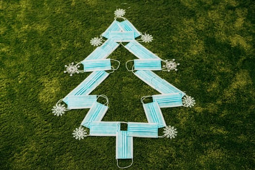 Medical Blue Masks Made Christmas Tree on a Green Background