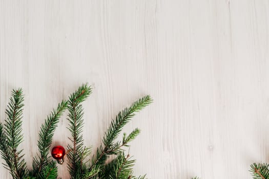 Christmas Composition on a White Wooden Table with Copy Space Text