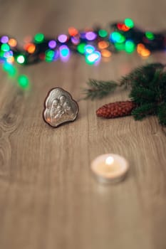 Christmas Composition of Church Icon on a Wooden Background With colored Light Boken