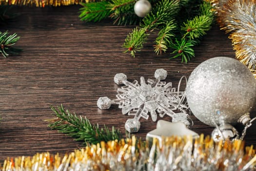 Decoration of Christmas Tree Green Branches on a Brown Background with Copy Space
