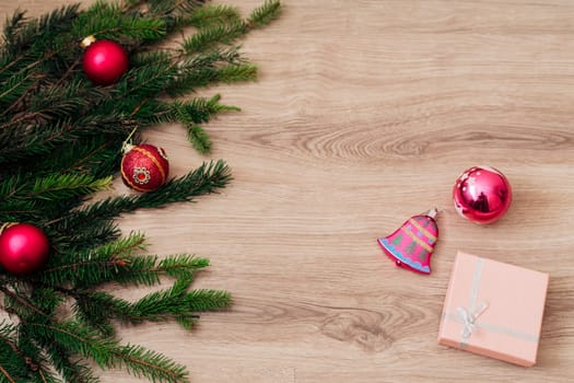 Decoration of Christmas Tree Green Branches on a Wooden Background with Copy Space