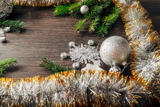 Decoration of Christmas Tree Green Branches on a Brown Background with Copy Space
