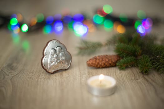 Christmas Composition of Church Icon on a Wooden Background With colored Light Boken