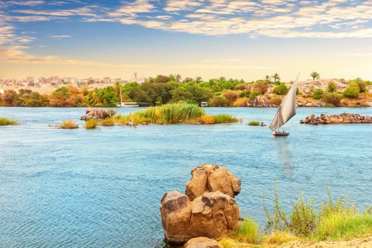 View on the Nile with a boat from the Nubian village, Aswan, Egypt.