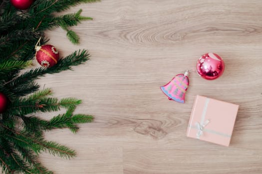 Decoration of Christmas Tree Green Branches on a Wooden Background with Copy Space