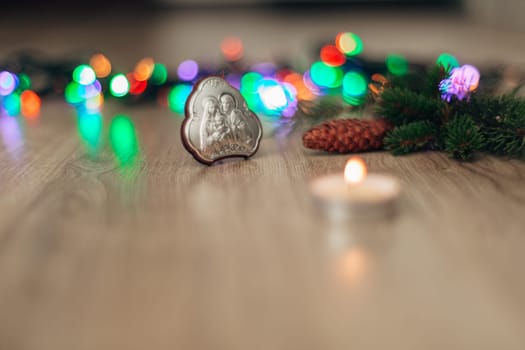 Christmas Composition of Church Icon on a Wooden Background With Multicolored Light Boken