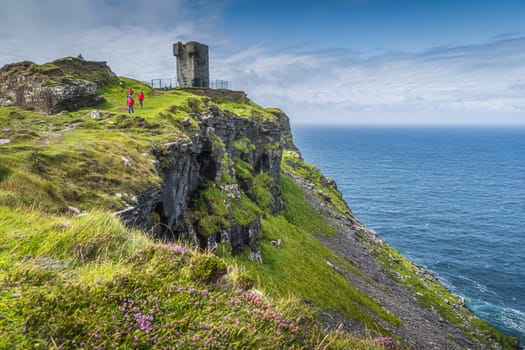 Tourists sightseeing Moher Tower on Hags Head, watchtower at the Cliffs of Moher, popular tourist attraction, Wild Atlantic Way, County Clare, Ireland