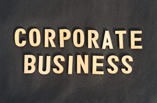 Corporate word and business concept. Wooden cubes words Corporate Business isolated on black background. Business Finance Industry concept.