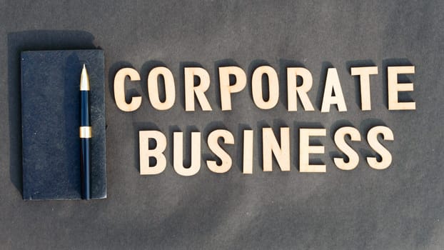 Corporate word and business concept. Wooden cubes words Corporate Business isolated on black background. Business Finance Industry concept.