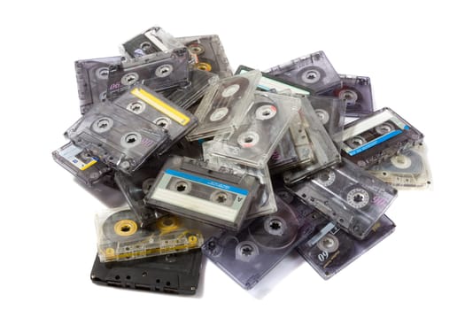 pile of audio compact cassettes on a white background