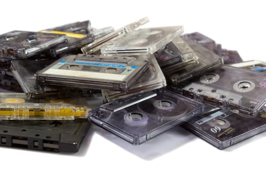 pile of audio compact cassettes on a white background