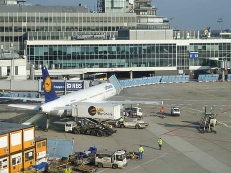 FRANKFURT, GERMANY - FEB 16, 2011: view to apron of Frankfurt airport with Lufthansa aircraft preparing for departure from skyshuttle.