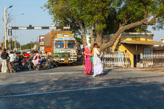 Fatehpur Sikri, India -  November 16, 2011: people wait at the railway crossing near Fatehpur Sikri, India to cross the street.