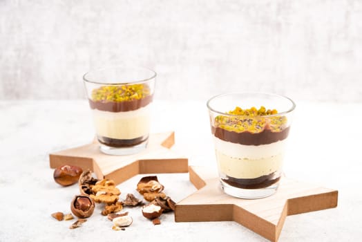 Dessert with chocolate cream, cake and nuts in a glass, sweet food, christmas season