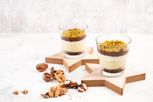Dessert with chocolate cream, cake and nuts in a glass, sweet food, christmas season