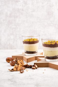 Dessert with chocolate cream, cake and nuts in a glass, sweet food, christmas season