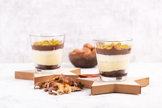 Dessert with chocolate cream, cake and nuts in a glass, sweet food, christmas season