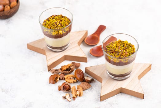 Dessert with chocolate cream, cake and nuts in a glass, sweet food, christmas season