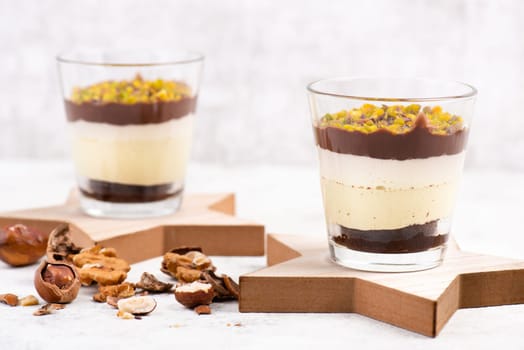Dessert with chocolate cream, cake and nuts in a glass, sweet food, christmas season