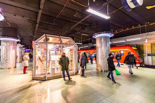 Frankfurt, Germany - February 27, 2018:  people wait inside the Station Hauptbahnhof (central station), the public transportation system waiting for next metro in Frankfurt