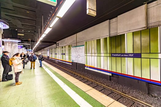 Frankfurt, Germany - February 27, 2018:  people wait inside the Station Hauptbahnhof (central station), the public transportation system waiting for next metro in Frankfurt