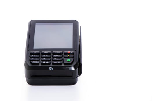 black payment terminal close-up for accepting money from plastic cards from customers on a white isolated background, copy space. High quality photo