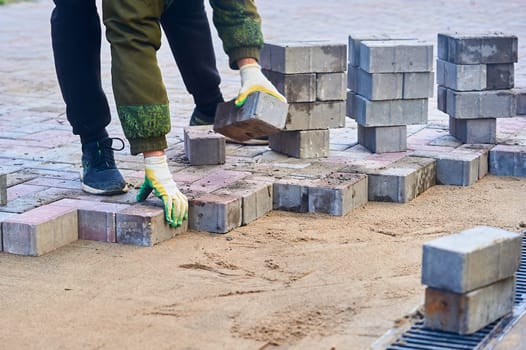 laying paving slabs on the sand with your hands. High quality photo