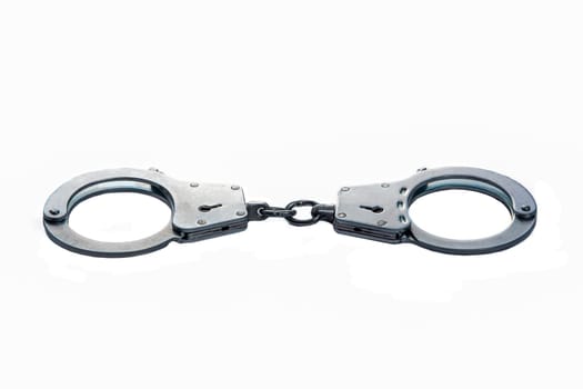 Metal handcuffs on a white isolated background. High quality photo