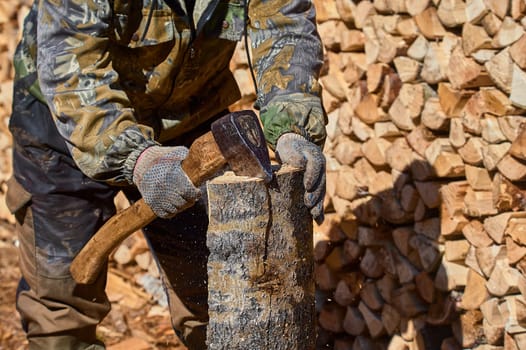 chopping firewood with a chopper close-up on a sunny day. High quality photo
