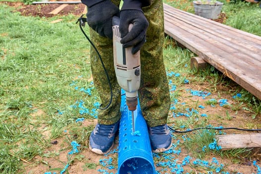drill holes in a plastic pipe. High quality photo