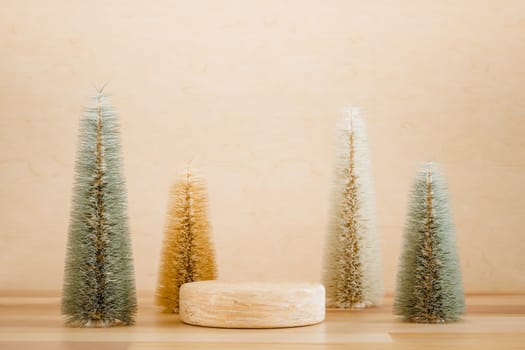 Wooden podium pedestal product mockup display with miniature Christmas trees in beige and green, 3d illustration