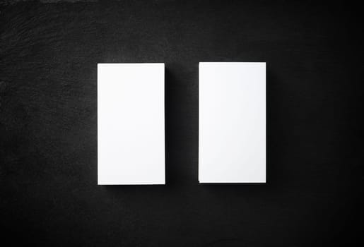 Two blank business cards on stone background. Mockup for branding identity. Studio shot. Flat lay.