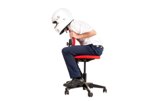 Businessman racing in a chair with helmet, isolated in white