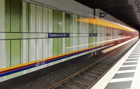 Frankfurt, Germany - March 3, 2019: blurred motion of metro train entering the train station in Frankfurt