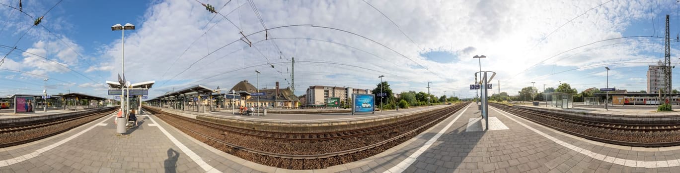Frankfurt, Germany - Jul 7, 2019: people waiting for the regional trains at the train station Frankfurt Hoechst in Germany. Frankfurt Hoechst ist the western outbound train station for Frankfurt.