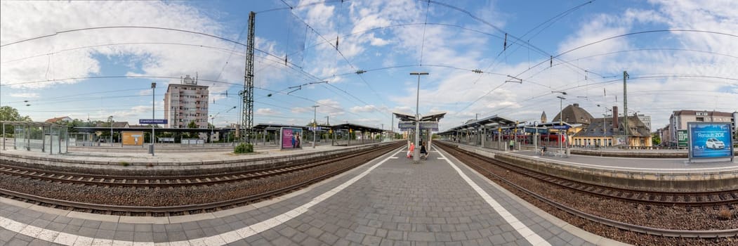 Frankfurt, Germany - Jul 7, 2019: people waiting for the regional trains at the train station Frankfurt Hoechst in Germany. Frankfurt Hoechst ist the western outbound train station for Frankfurt.